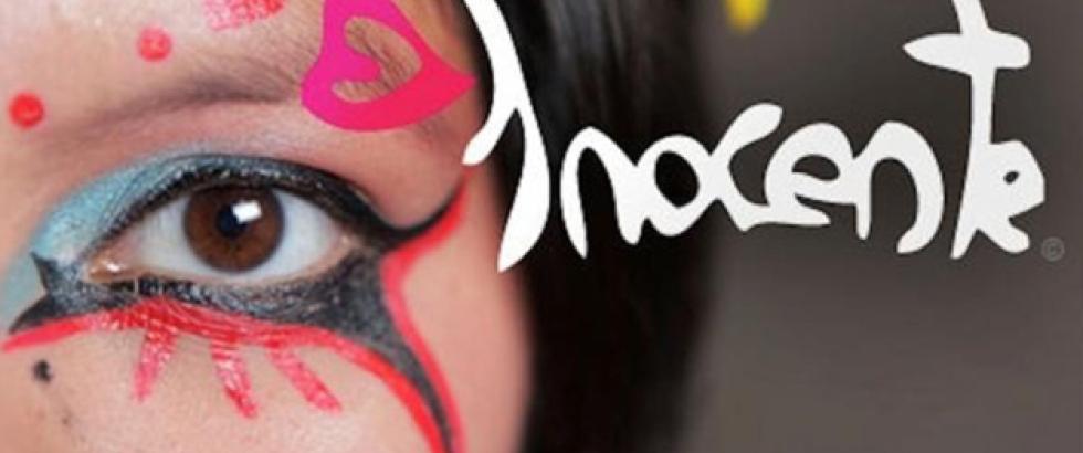 Word Inocente is written next to a half face profile of a woman with vibrant eye makeup