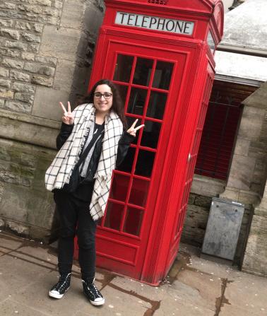 Brandi Ortiz in Oxford in front of a red phone booth.