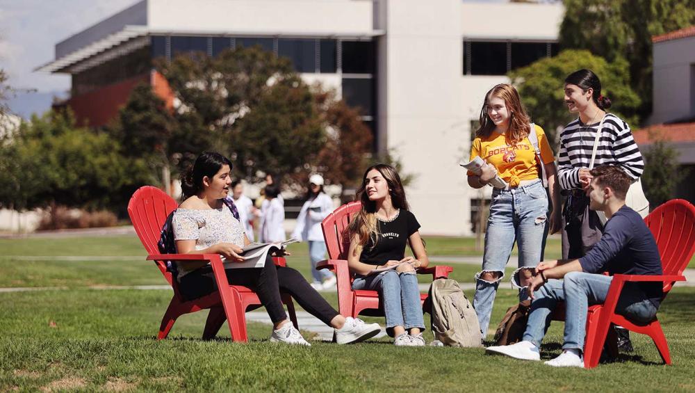 Saddleback College students sitting in group outside