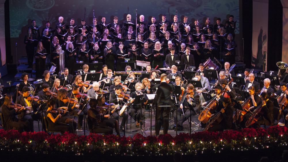 The Saddleback College Symphony Orchestra and college choirs perform on the stage of the McKinney Theatre.