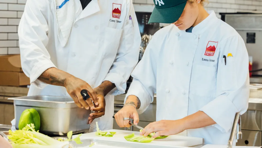 Two students doing meal prep in ATEP kitchen.