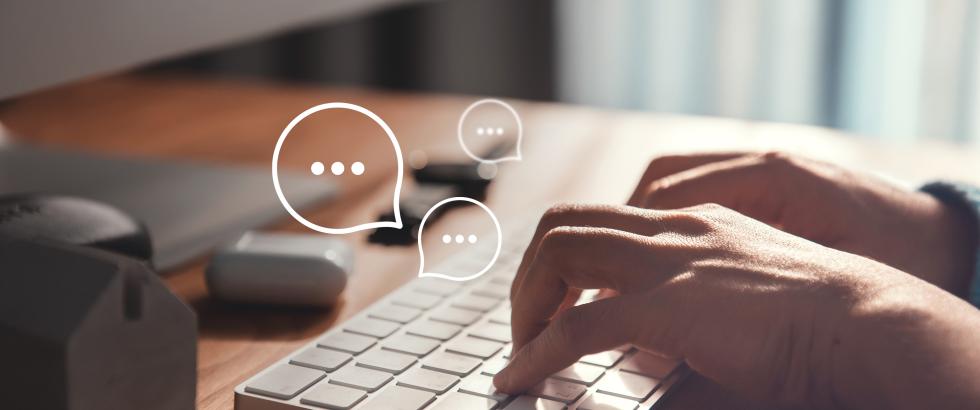 Hands typing on a keyboard with word bubbles appearing