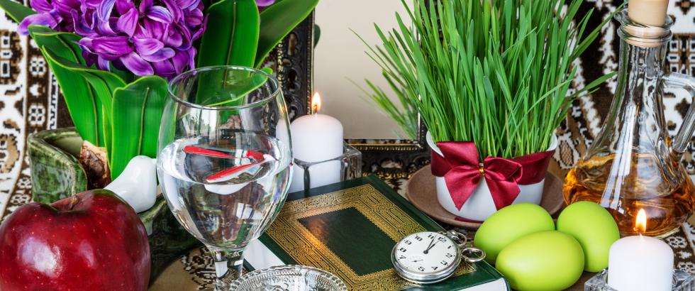 Image items typically found at Nowruz including apple, wheatgrass, Samanu, dried fruit of a lotus tree, garlic, sumac, and vinegar.