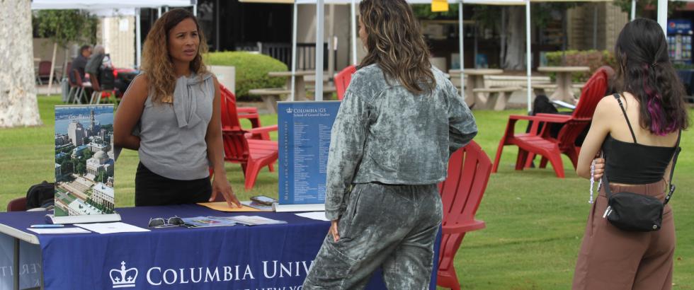 Student speaking to a rep from a university at the transfer fair