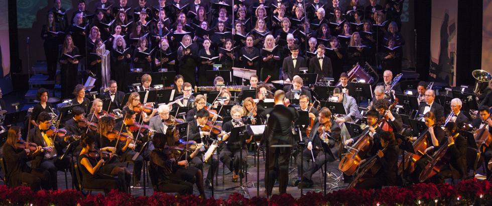 The Saddleback College Symphony Orchestra and college choirs perform on the stage of the McKinney Theatre.