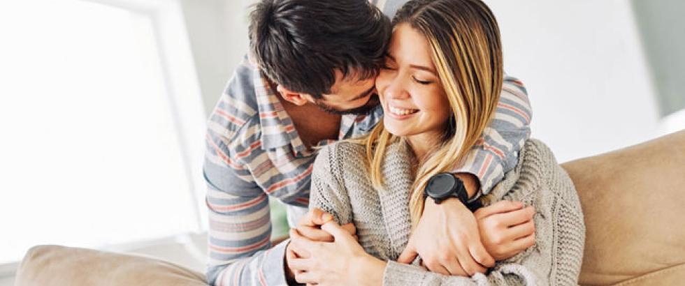 Male hugging his female partner.