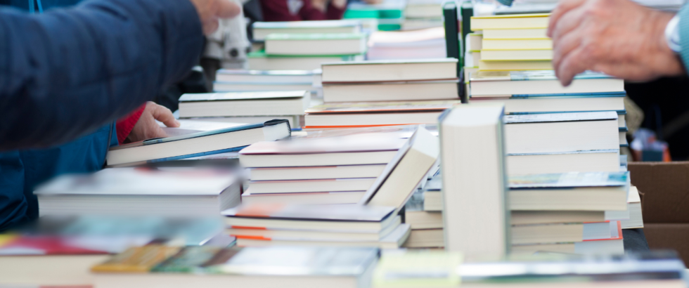 A table full of used books.