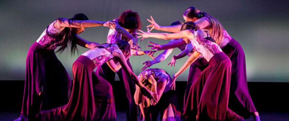 Students performing dances on stage