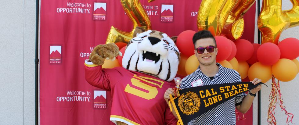 Mascot and student holding CSULB pennent.