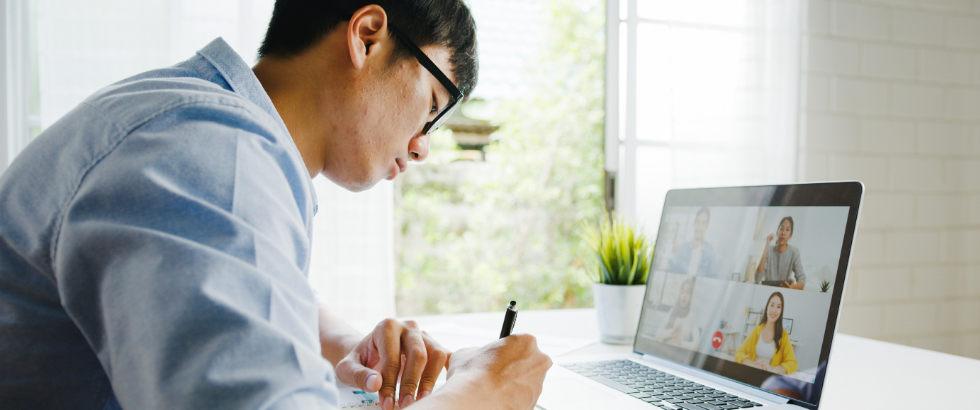 Young male using laptop talk to about plan in video call meeting while work from home at living room