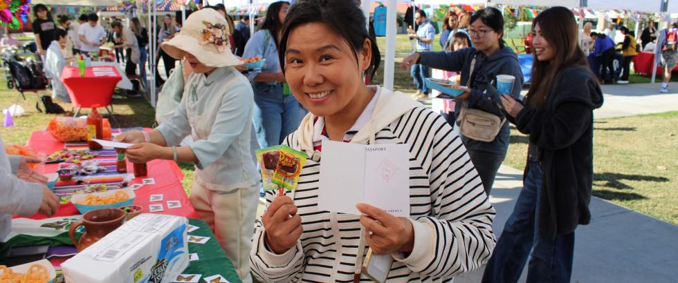 female holding candy surrounded by other adults at an event