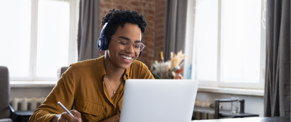 cheerful college student in earphones attending virtual class