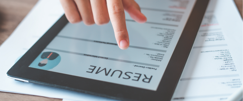 person filling out their personal resume on a tablet