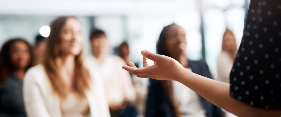 cropped shot of a businesswoman delivering a speech during a conference
