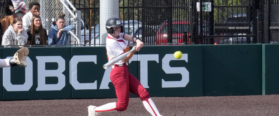female softball player at bat