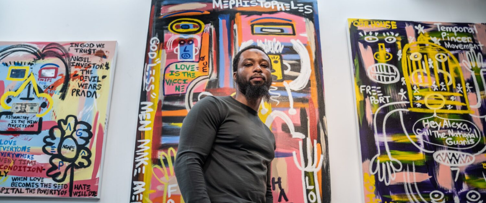 Halim Flowers, a celebrated artist, poet, and advocate for criminal justice reform stands before his artwork