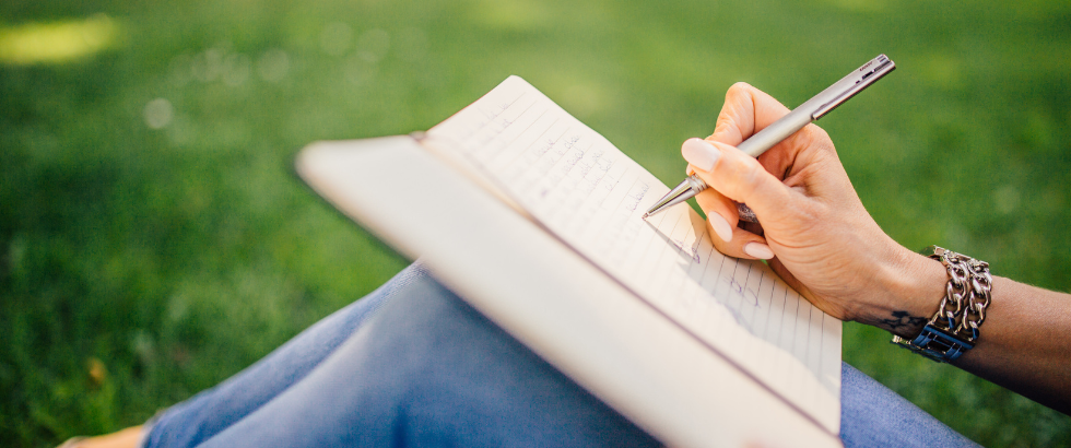 person writing on white paper
