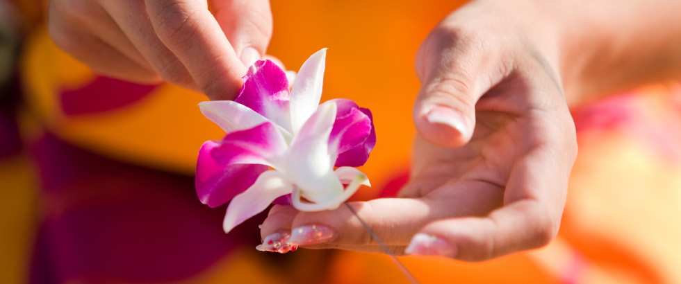 hands making a flower lei