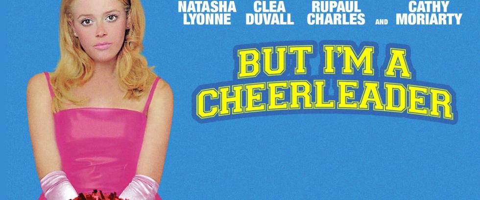 bright blue background. picture on left of actor natasha lyonne. she has blond hair, pink lipstick, pink dress, pink long silky gloves, red pompom. text includes the names of several actors: Natasha Lyonne, Clea Duvall, Rupaul Charles, and Cathy Moriarty. Movie title: But I'm a Cheerleader