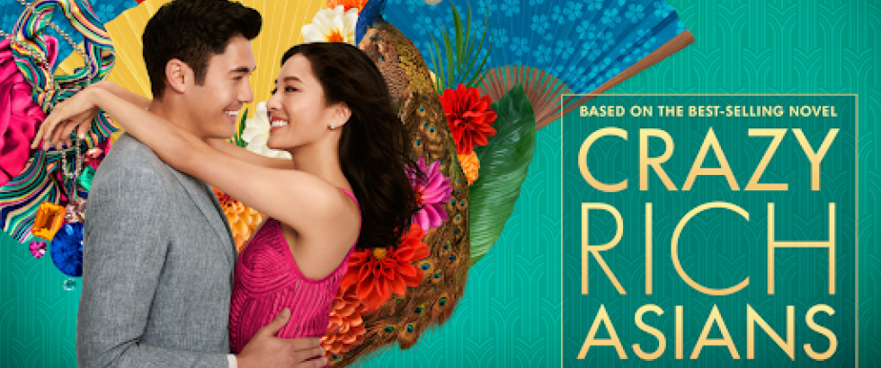 A movie poster shows a man and a woman holding each other and smiling