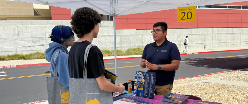 Two Saddleback College students speak to a representative from the University of San Diego during the Transfer Fair event.