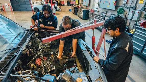 Students at ATEP working on an engine block.