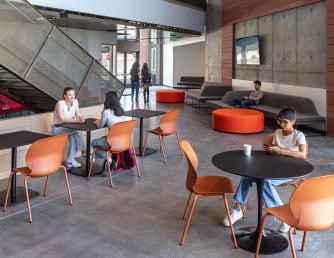 Students sitting at tables in the ATAS building