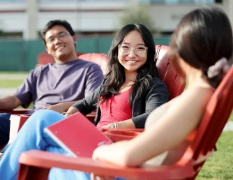 Students sitting talking on the quad.