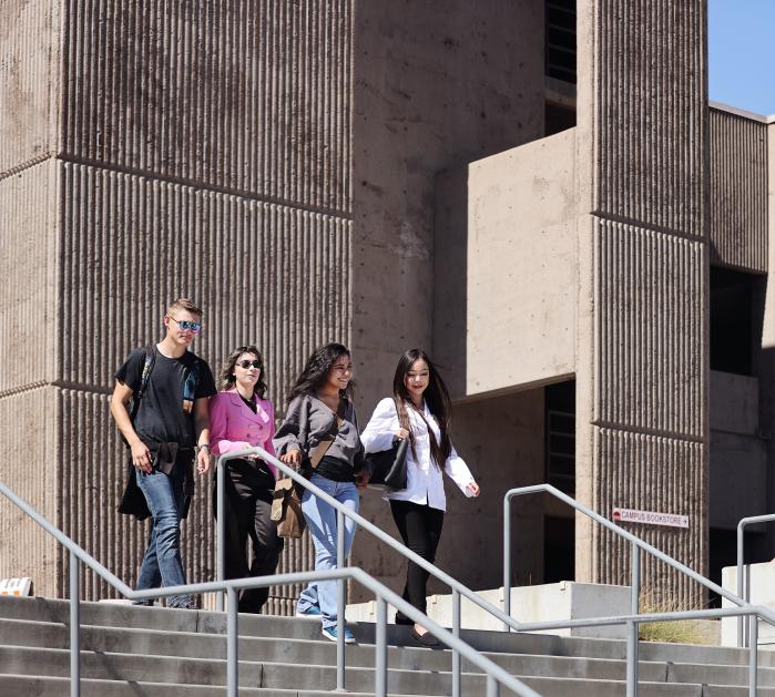 Saddleback College students walking down stairs outside.