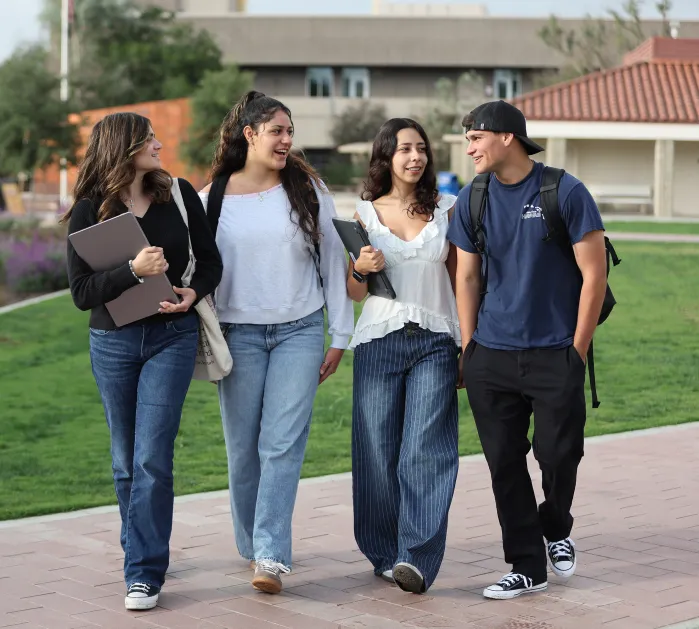 Four students walking and having a conversation.