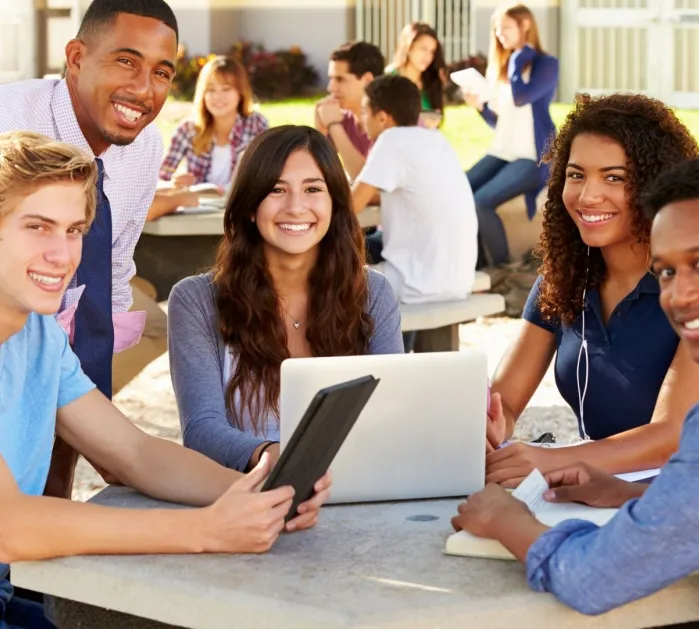 Group of diverse students sitting at a table.