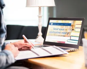 Image of an open laptop with a college application page pulled up on the screen.