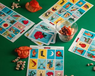 Image of loteria cards spread on a green table cloth