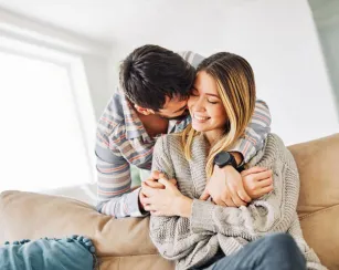 Male hugging his female partner.