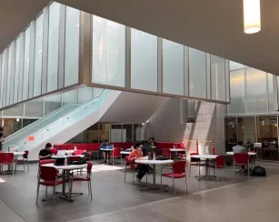 Students sitting at various tables in the Library Resource Center (LRC)