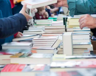 A table full of used books.