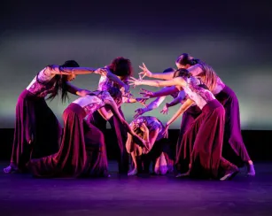 Students performing dances on stage