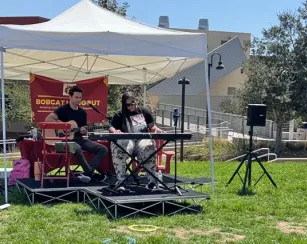 Grooving on the grass featuring artist Dazmin D'Leon playing keyboard.