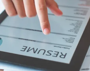 person filling out their personal resume on a tablet