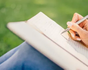 person writing on white paper