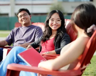 Students sitting talking on the quad.
