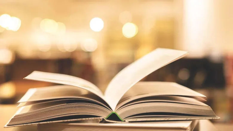 Image to two books and the top book is opened to center pages