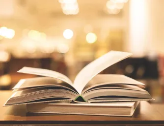 Image to two books and the top book is opened to center pages