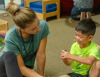 Saddleback Student working with child in childcare