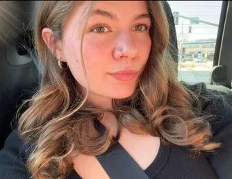 female sitting in her car