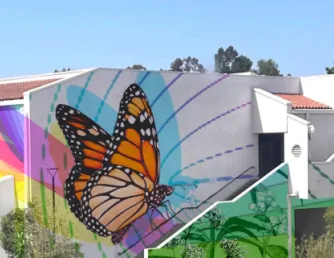 Rendering of a colorful butterfly mural planned for the BGS building. The design features large monarch butterflies in flight against rainbow and gradient backgrounds, with floral and nature motifs along the lower walls. The mural spans multiple sides of the building and will be painted in the coming weeks.
