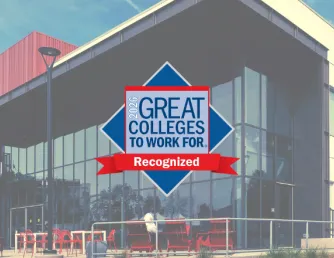 In the background of the image is a picture of the Gateway building at Saddleback College. Over it is a logo that reads, Great Colleges to Work For. Recognition.