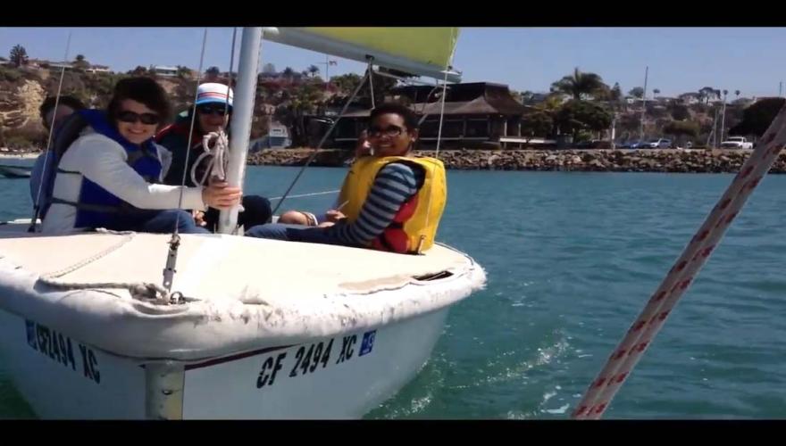 Students on small sailboat.